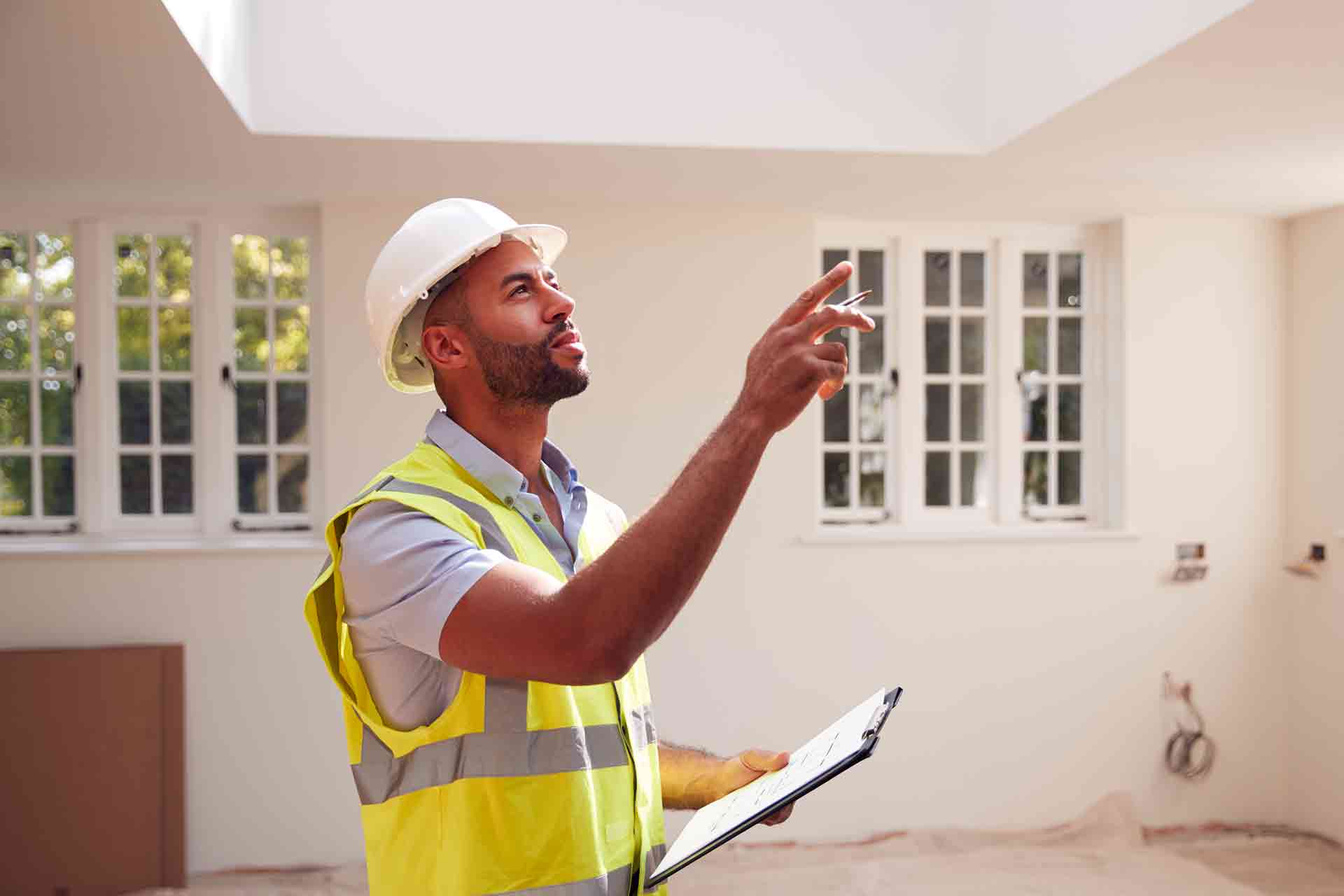 Third Party Wall Surveyors Hitchin reviewing plans between two parties during a dispute